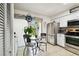 Eat-in kitchen with stainless steel appliances, white cabinetry, and view of front door at 6630 Spring Flower Dr # 14, New Port Richey, FL 34653