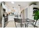Bright kitchen offers stainless appliances, white cabinets and tile flooring with adjacent dining area at 6630 Spring Flower Dr # 14, New Port Richey, FL 34653