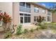 Exterior of screened patio with brick pavers and mature landscaping at 6630 Spring Flower Dr # 14, New Port Richey, FL 34653