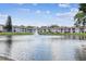 Apartment building overlooking a scenic pond with a fountain and lush landscaping at 6630 Spring Flower Dr # 14, New Port Richey, FL 34653