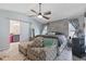 Serene main bedroom showcasing a stylish ceiling fan and a view into the ensuite bath at 6645 Freeport Dr, Spring Hill, FL 34608