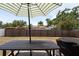 A backyard set up with a picnic table with umbrella and outdoor kitchen at 6817 S Gabrielle St, Tampa, FL 33611
