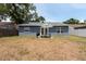 This cozy backyard has a BBQ, picnic table, and white picket fence at 6817 S Gabrielle St, Tampa, FL 33611