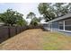 Spacious fenced backyard with picnic table offering ample outdoor space for relaxation and recreation at 6817 S Gabrielle St, Tampa, FL 33611