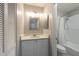 Bathroom features a vanity with storage and shower with white tiling at 6817 S Gabrielle St, Tampa, FL 33611