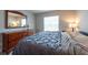 Cozy bedroom with wood floors, dresser, and lots of natural light at 6817 S Gabrielle St, Tampa, FL 33611