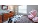 Bedroom featuring wood floors, dresser, and cute decor at 6817 S Gabrielle St, Tampa, FL 33611
