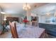 Open dining area with modern lighting and easy access to the living room and kitchen areas at 6817 S Gabrielle St, Tampa, FL 33611