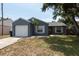 Charming home with a one-car garage and a well-maintained lawn, providing a cozy curb appeal at 6817 S Gabrielle St, Tampa, FL 33611