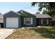 Attractive home with garage and tidy landscaping, showcasing its appealing curb presence at 6817 S Gabrielle St, Tampa, FL 33611