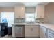 Bright kitchen features white cabinets, stainless steel appliances, and stylish backsplash at 6817 S Gabrielle St, Tampa, FL 33611