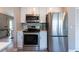 Modern kitchen featuring stainless steel appliances, white cabinets, and stylish backsplash at 6817 S Gabrielle St, Tampa, FL 33611