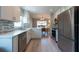 Modern kitchen featuring white cabinets, stainless steel appliances, and an adjacent dining area at 6817 S Gabrielle St, Tampa, FL 33611