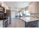 Well-lit kitchen featuring modern appliances, sleek countertops, and convenient access to the adjacent dining area at 6817 S Gabrielle St, Tampa, FL 33611