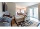Cozy living room with a large comfy couch, rug, and sliding glass doors to the backyard at 6817 S Gabrielle St, Tampa, FL 33611