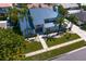 Aerial view of a two story home with metal roof, a driveway and manicured lawn and landscaping at 7114 Pelican Island Dr, Tampa, FL 33634