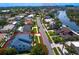 This home features an aerial view of a waterfront community with beautiful palm trees and lush landscaping at 7114 Pelican Island Dr, Tampa, FL 33634