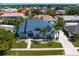 Aerial view of a two story home with metal roof in a tropical waterfront community at 7114 Pelican Island Dr, Tampa, FL 33634