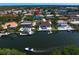 Aerial view of a two story home in a waterfront neighborhood with boat docks on the canal at 7114 Pelican Island Dr, Tampa, FL 33634