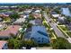 Aerial view of home in a tropical setting with mature landscaping at 7114 Pelican Island Dr, Tampa, FL 33634