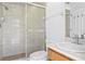 Well-lit bathroom featuring a glass-enclosed shower and vanity with a white sink and modern faucet at 7114 Pelican Island Dr, Tampa, FL 33634