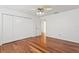 Bright bedroom featuring hardwood floors, a ceiling fan, and a large closet at 7114 Pelican Island Dr, Tampa, FL 33634