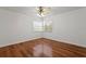 Well-lit bedroom featuring hardwood floors, neutral walls, and a ceiling fan at 7114 Pelican Island Dr, Tampa, FL 33634