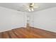 Bright bedroom featuring hardwood floors, a ceiling fan, and a large closet at 7114 Pelican Island Dr, Tampa, FL 33634