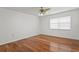 Bright bedroom featuring hardwood floors and a large window at 7114 Pelican Island Dr, Tampa, FL 33634