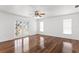 Spacious bedroom boasts hardwood floors, ceiling fan, and a private balcony at 7114 Pelican Island Dr, Tampa, FL 33634