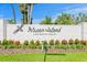 Entrance to deed restricted Pelican Island community with manicured landscaping and gray pelican statue at 7114 Pelican Island Dr, Tampa, FL 33634
