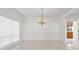 Dining room with large window, chandelier, ceramic floors and neutral paint at 7114 Pelican Island Dr, Tampa, FL 33634