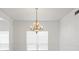 Dining room features a chandelier, large window with blinds, ceramic floors and neutral paint at 7114 Pelican Island Dr, Tampa, FL 33634
