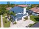 Stunning two-story home boasts lush landscaping, a spacious driveway, and a unique blue metal roof at 7114 Pelican Island Dr, Tampa, FL 33634