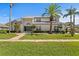 Stunning two-story home boasts lush landscaping, a manicured lawn, and a striking gray roof at 7114 Pelican Island Dr, Tampa, FL 33634