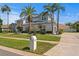 Beautiful two story home with a metal roof and palm trees in a well landscaped yard at 7114 Pelican Island Dr, Tampa, FL 33634