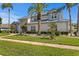 Beautiful two story home with a metal roof and palm trees in a well landscaped yard at 7114 Pelican Island Dr, Tampa, FL 33634