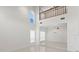Bright foyer with soaring ceilings, ceramic floors and a view of the second story gallery at 7114 Pelican Island Dr, Tampa, FL 33634