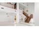Grand foyer with a staircase, chandelier, ceramic floors and a view of the second story gallery at 7114 Pelican Island Dr, Tampa, FL 33634