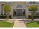 Beautiful front entry with a gray double door and a matching keystone window above at 7114 Pelican Island Dr, Tampa, FL 33634