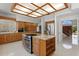Spacious kitchen boasts wood cabinets, granite counters, stainless steel appliances, and a large island cooktop at 7114 Pelican Island Dr, Tampa, FL 33634