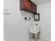 Practical laundry room with a utility sink, upper cabinet, and a clean, functional design at 7114 Pelican Island Dr, Tampa, FL 33634