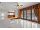 Living room with tile flooring, wood paneling, and large windows overlooking pool at 7114 Pelican Island Dr, Tampa, FL 33634
