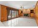 Inviting living room with brick fireplace, wood paneled walls, and french doors leading to the patio at 7114 Pelican Island Dr, Tampa, FL 33634