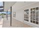 Covered patio featuring durable tile floors and access to the home's interior at 7114 Pelican Island Dr, Tampa, FL 33634