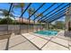 Relaxing screened pool surrounded by lush landscaping, offering a private oasis for leisure and recreation at 7114 Pelican Island Dr, Tampa, FL 33634