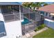 An elevated view of the screened-in pool enclosure, with an adjacent patio at 7114 Pelican Island Dr, Tampa, FL 33634