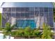 A high angle view of the enclosed pool with a view of palm trees and neighboring houses at 7114 Pelican Island Dr, Tampa, FL 33634