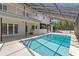 Stunning pool area with a large swimming pool and a covered patio, perfect for relaxation and entertaining at 7114 Pelican Island Dr, Tampa, FL 33634