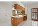 Bright wet bar featuring wooden countertop and cabinets with sink and views of the pool at 7114 Pelican Island Dr, Tampa, FL 33634